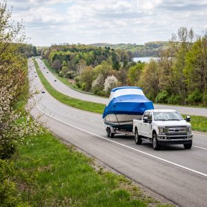 Ship A Boat trailer hauling a recreational boat from Florida, highlighting early spring transport planning to Michigan